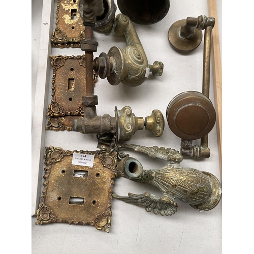 104 - Assortment of cast brass tap fittings, bell & brass switch plates
