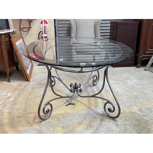 1154 - Oval Glass top table with scrolling metal base, approx 77cm H x 190cm W x 119cm D