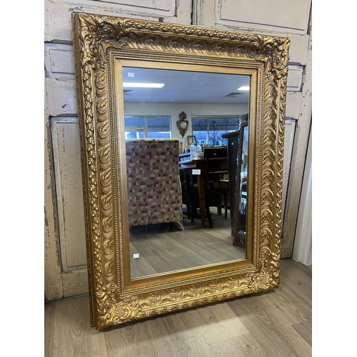 1160 - Decorative gilt surround wall mirror, approx 123cm x 92cm