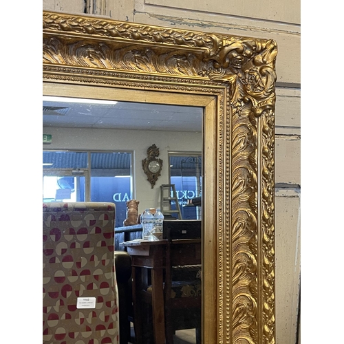 1160 - Decorative gilt surround wall mirror, approx 123cm x 92cm