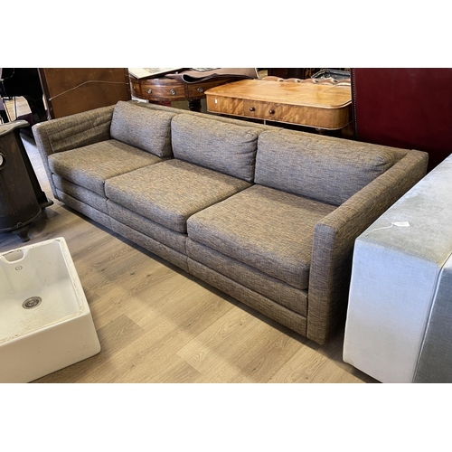 1195 - Modern charcoal coloured upholstered four seater couch, approx 230cm W