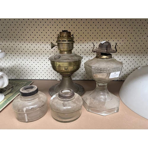 64 - Assorted antique oil lamp bases, along with a Millers milk glass shade, approx 35cm Dia and smaller