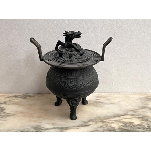 165 - Asian cast bronze tri leg lidded censer, the cover pierced and cast with a dragon, approx 20cm H