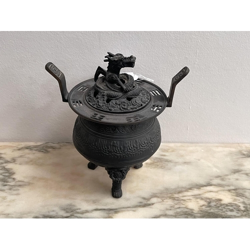 165 - Asian cast bronze tri leg lidded censer, the cover pierced and cast with a dragon, approx 20cm H