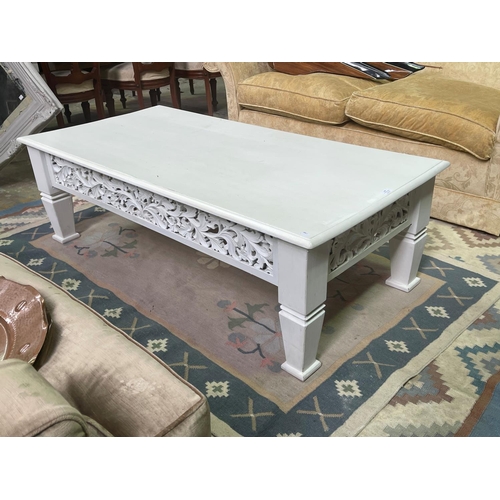 276 - White painted teak coffee table, approx 150cm L x 64cm