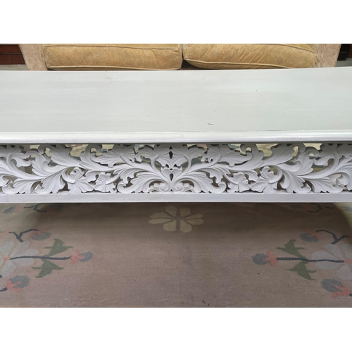 276 - White painted teak coffee table, approx 150cm L x 64cm