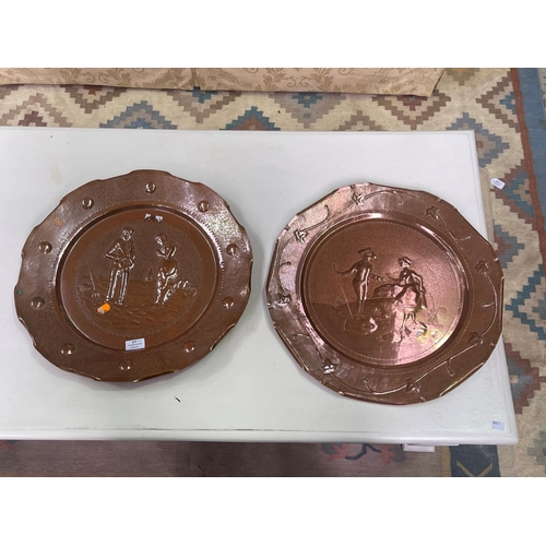 277 - Two large French hand worked copper wall trays, decorated in relief,  each approx 50cm Dia (2)