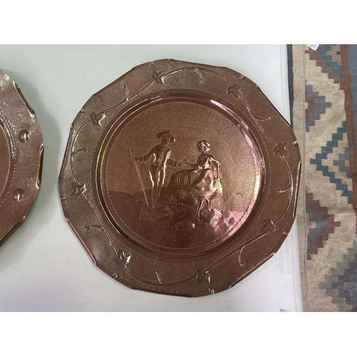 277 - Two large French hand worked copper wall trays, decorated in relief,  each approx 50cm Dia (2)