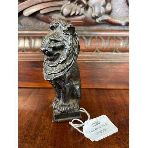 1230 - Antique cast iron figure of a seated lion, indistinct signature to base, approx 12cm H