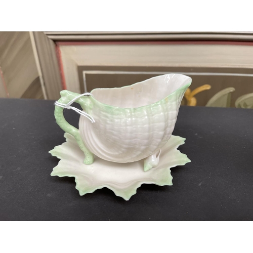 123 - Antique Belleek shell form creamer and a Belleek pin dish, both with black print (2)