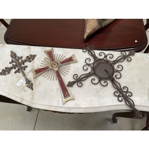 244 - Three metal crosses, one with drop down candle sconce pan, approx 57cm and smaller (2)