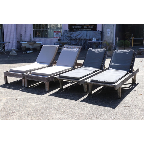 128 - Two matched pairs of wooden outdoor sun lounges with cushions, approx 34cm H x 227cm L (including wh... 