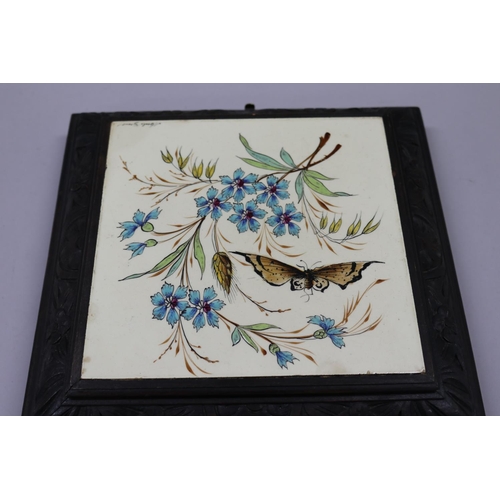136 - French porcelain musical tile plat, wooden frame, decorated with flowers & butterfly, signed Merlo G... 