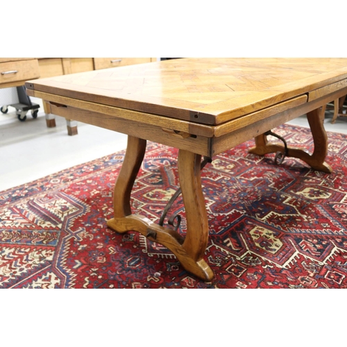 158 - French 18th century style Spanish oak parquetry top dining table, with hand forged wrought iron stre... 