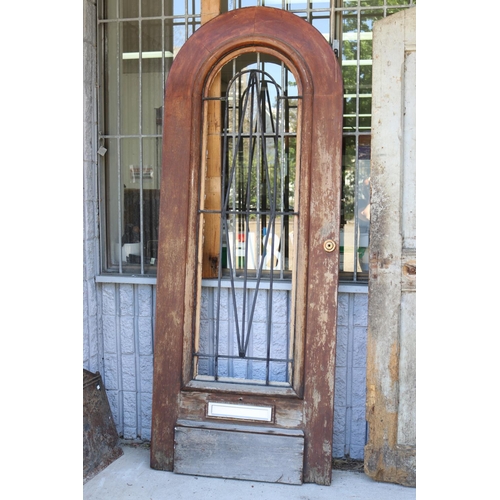 216 - French Art Deco arched top entrance door, wrought iron panel, letter box slot, approx 222cm H x 85cm... 