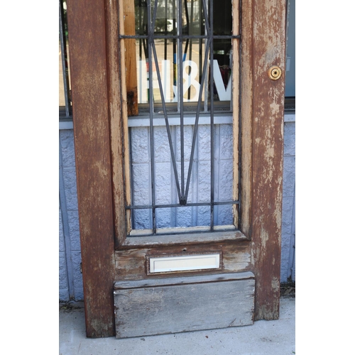 216 - French Art Deco arched top entrance door, wrought iron panel, letter box slot, approx 222cm H x 85cm... 