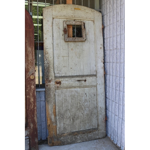 217 - Antique French prison door, in original rustic condition, chicken wire hole, archer top, approx 220c... 
