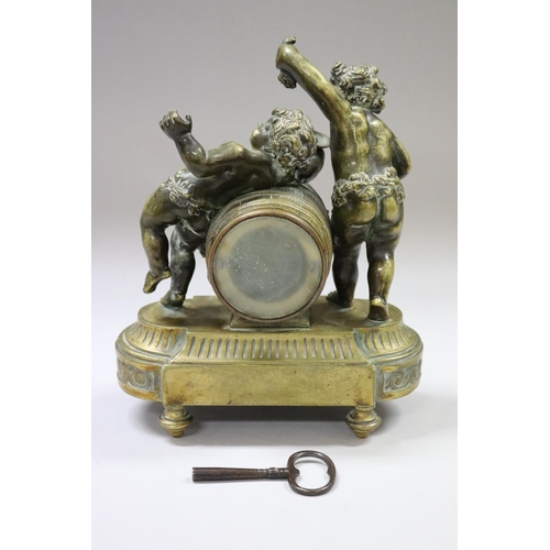 52 - Antique French figural ladies desk clock, surmounted with two putti, one feeding grapes, the other w... 