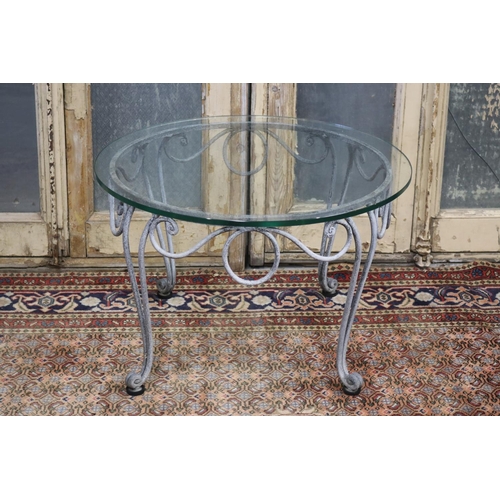 125 - La Forge glass top wrought iron coffee table, approx 41cm H x 65cm dia