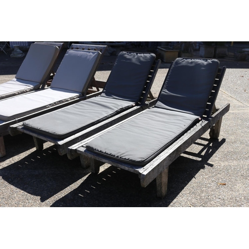 128 - Two matched pairs of wooden outdoor sun lounges with cushions, approx 34cm H x 227cm L (including wh... 