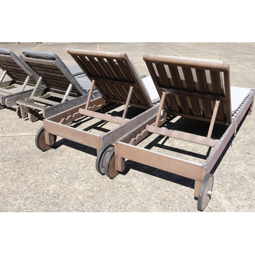 128 - Two matched pairs of wooden outdoor sun lounges with cushions, approx 34cm H x 227cm L (including wh... 