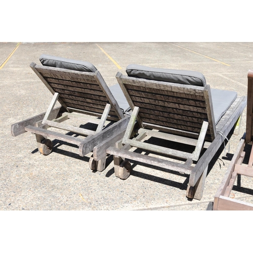 128 - Two matched pairs of wooden outdoor sun lounges with cushions, approx 34cm H x 227cm L (including wh... 