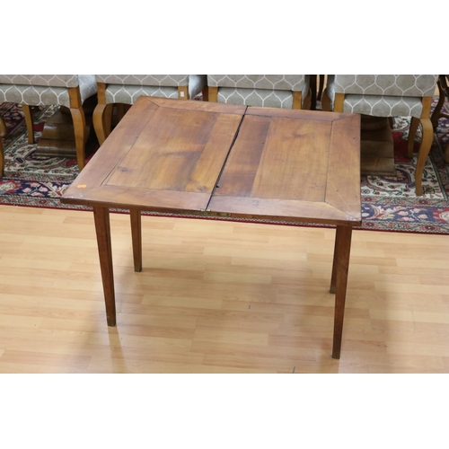 233 - Antique early 19th century French cherrywood fold over table, standing on square tapering legs, appr... 