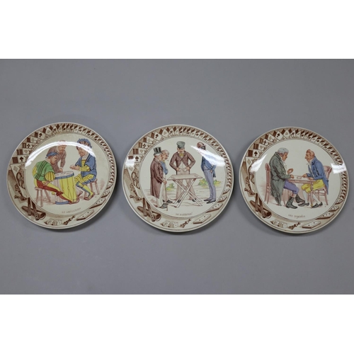 46 - Set of twelve antique French Sarreguemines porcelain plates, showing different scenes of gaming, mar... 