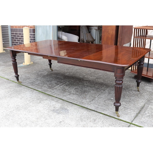 1221 - Antique mahogany extension dining table with two leaves, standing on turned fluted legs, with replac... 