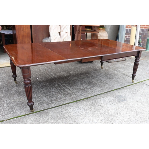 1221 - Antique mahogany extension dining table with two leaves, standing on turned fluted legs, with replac... 