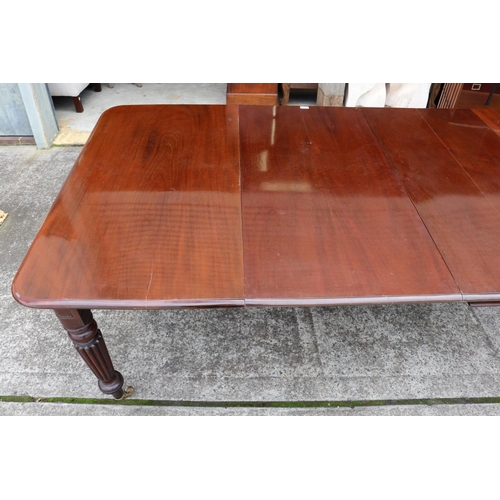 1221 - Antique mahogany extension dining table with two leaves, standing on turned fluted legs, with replac... 