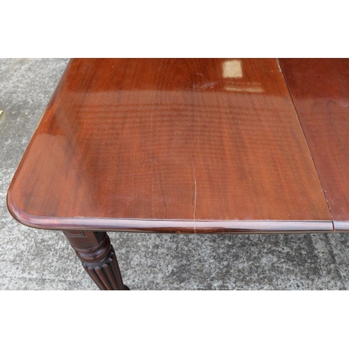 1221 - Antique mahogany extension dining table with two leaves, standing on turned fluted legs, with replac... 