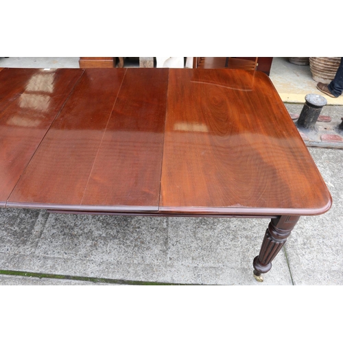 1221 - Antique mahogany extension dining table with two leaves, standing on turned fluted legs, with replac... 