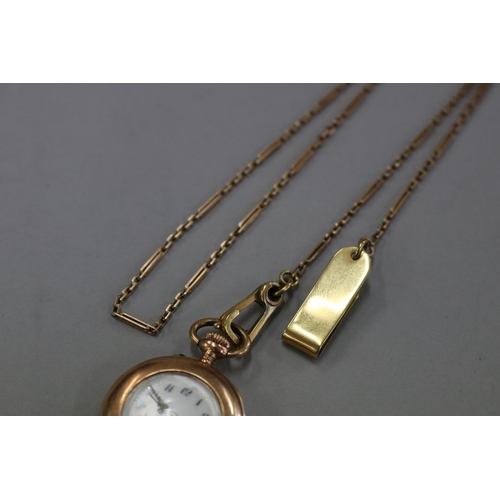 172 - Antique keyless ladies (585) marked fob watch, enamel dial, with attached fine albert gold chain and... 