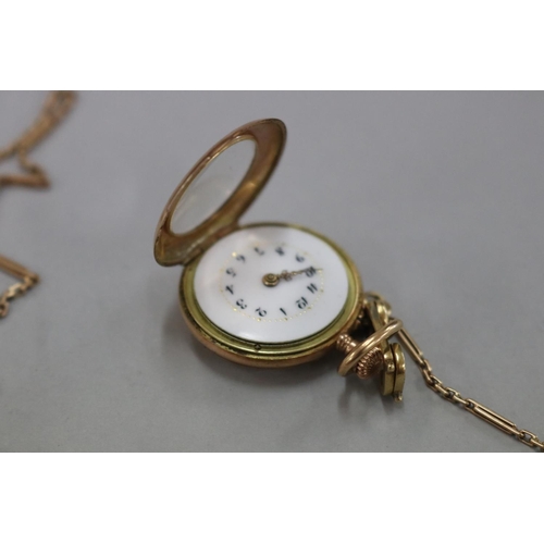 172 - Antique keyless ladies (585) marked fob watch, enamel dial, with attached fine albert gold chain and... 