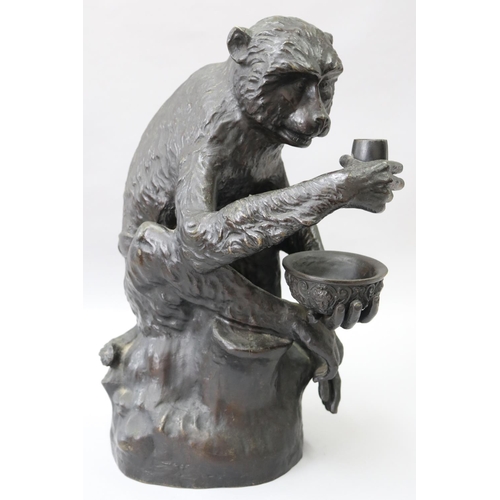 22 - Large cast bronze of a seated monkey holding a bowl and pipe, signed to back Panigatti, approx 43cm ... 