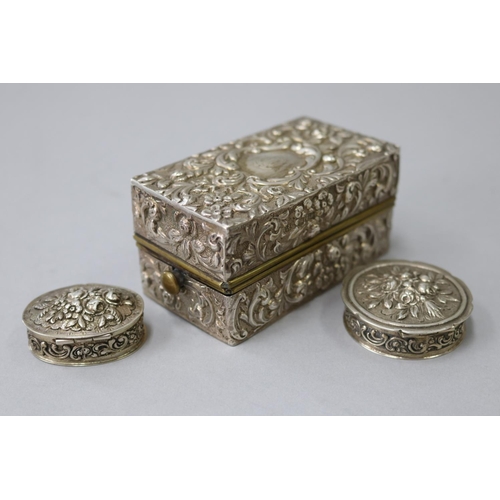 23 - Antique repousse sterling silver lift top box, with liner, London 1898, along with two European 835 ... 