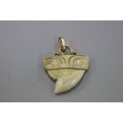 258 - Shark tooth inlaid with gold and 18ct gold mount, slightly rubbed, scratched into the top of tooth, ... 