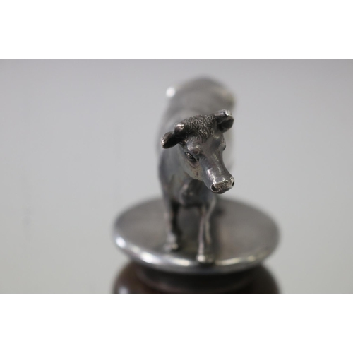 26 - Unmarked cast metal figure of a cow, mounted on a turned oak base, approx 12.5cm H