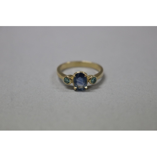 291 - Natural blue sapphire and two green stone diamond ring set in 9ct gold