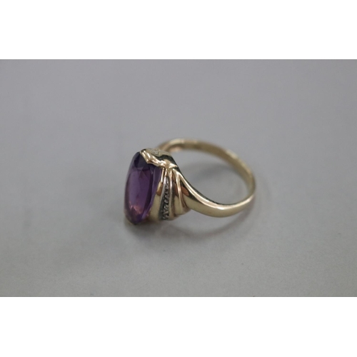 306 - 9ct gold and amethyst ring with small diamonds