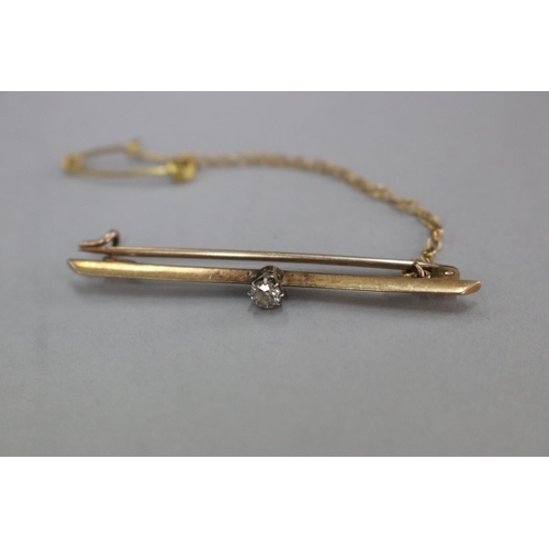 312 - 15ct gold and diamond bar brooch