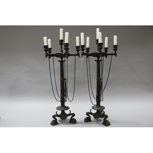33 - Pair of bronze Empire six stick candelabra, with chains, over squat paw feet, each approx 68cm H (2)