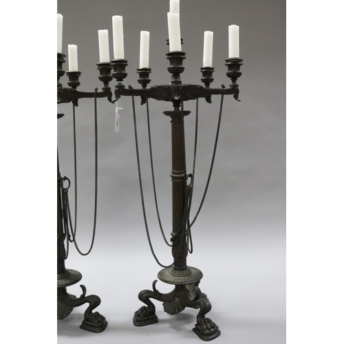 33 - Pair of bronze Empire six stick candelabra, with chains, over squat paw feet, each approx 68cm H (2)