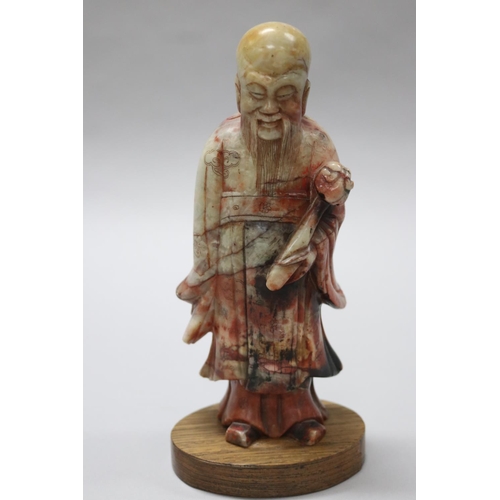 72 - Antique early 20th century Chinese two colour jade figure of a god, holding a sceptre, wooden base, ... 