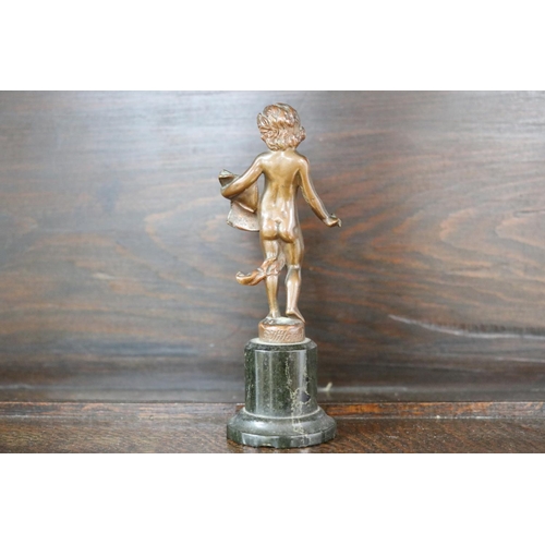 73 - Small antique bronze of a semi clad young boy holding a book - signed to back, chipped at base, appr... 