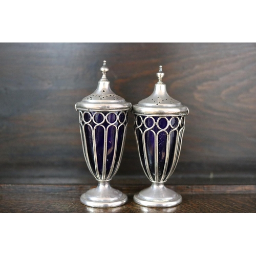 75 - Pair of antique urn form pepper pots with blue liners, marked for Birmingham, each approx 10cm H & a... 
