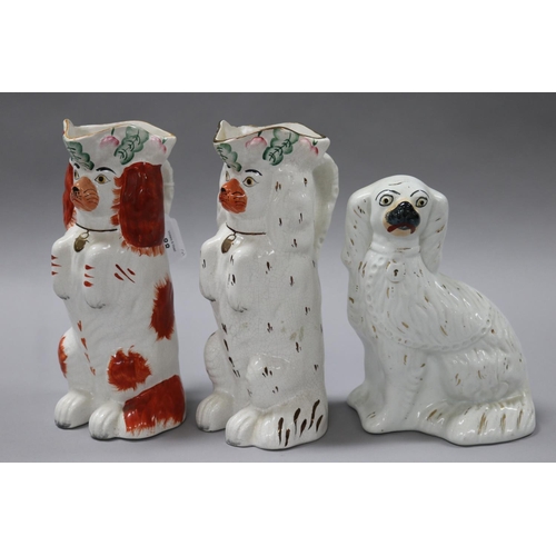 88 - Two Staffordshire begging dog jugs along with a white Staffordshire figure of a dog, approx 26cm H a... 