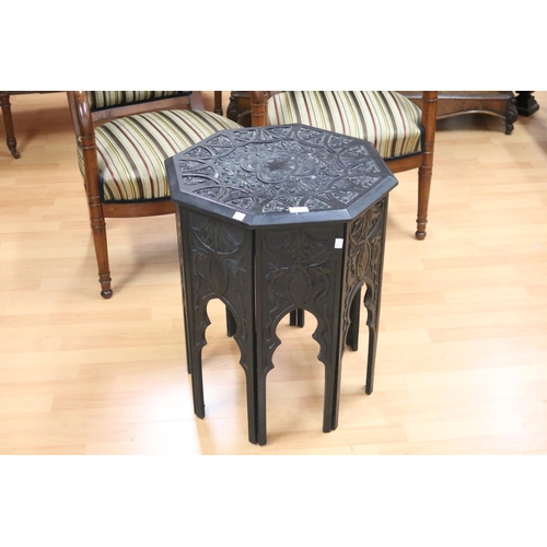 123 - Octagonal well carved ebonized Persian inspired table, approx 60cm H x 48cm Dia