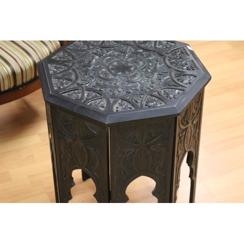 123 - Octagonal well carved ebonized Persian inspired table, approx 60cm H x 48cm Dia